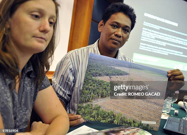 Greenpeace forest campaigners Bustar Maitar and Suzanne Kroeger display recent a photograph showing cleared forest for palm oil in Sinar Mas...