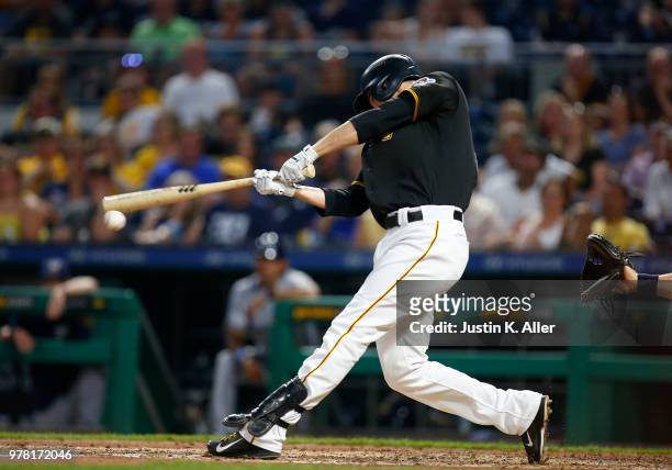 Jordy Mercer of the Pittsburgh Pirates hits a RBI double in the seventh inning against the Milwaukee Brewers at PNC Park on June 18, 2018 in...