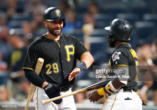 Francisco Cervelli of the Pittsburgh Pirates celebrates with Josh Harrison of the Pittsburgh Pirates after scoring on a RBI double in the seventh...