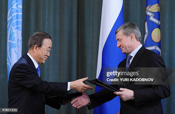 Secretary General Ban Ki Moon exchanges signed documents with head of the Collective Security Treaty Organization Nikolai Bordyuzha at a press...