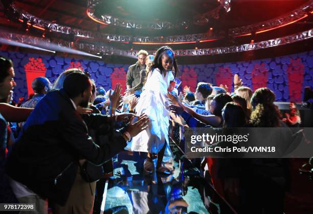 Host Tiffany Haddish accepts the Best Comedic Performance award for 'Girls Trip' onstage from actors Kristen Bell and Seth Rogen during the 2018 MTV...