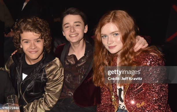 Actors Gaten Matarazzo, Noah Schnapp, and Sadie Sink attend the 2018 MTV Movie And TV Awards at Barker Hangar on June 16, 2018 in Santa Monica,...