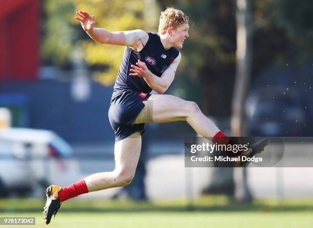 Clayton Oliver of the Demons kicks the ball during a Melbourne Demons AFL training session at Gosch's Paddock on June 19, 2018 in Melbourne,...