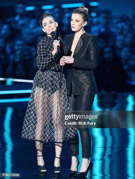 Actors Alison Brie and Betty Gilpin speak onstage during the 2018 MTV Movie And TV Awards at Barker Hangar on June 16, 2018 in Santa Monica,...