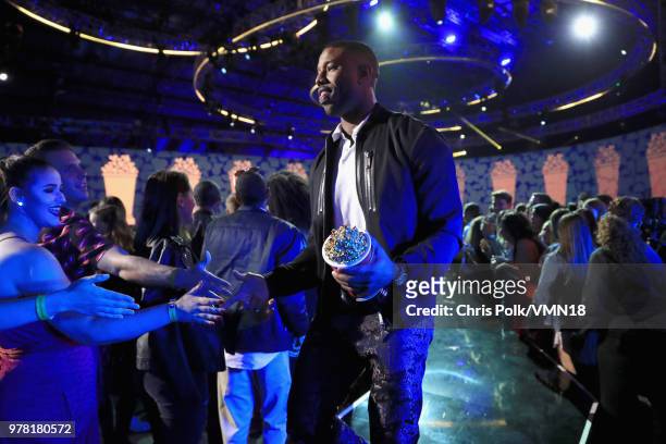 Actor Michael B. Jordan, winner of the Best Villain award for 'Black Panther', walks off stage during the 2018 MTV Movie And TV Awards at Barker...