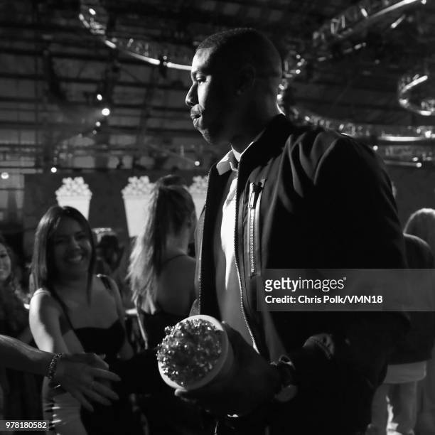 Actor Michael B. Jordan, winner of the Best Villain award for 'Black Panther', walks off stage during the 2018 MTV Movie And TV Awards at Barker...