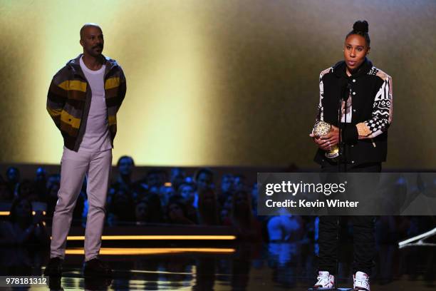 Actor-recording artist Common listens to honoree Lena Waithe accept the MTV Trailblazer Award onstage during the 2018 MTV Movie And TV Awards at...