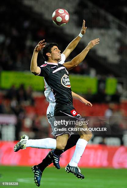 Sevilla's Brazilian midfielder Renato vies with Deportivo's forward Juan Dominguez during a Spanish league football match at Sanchez Pizjuan stadium...