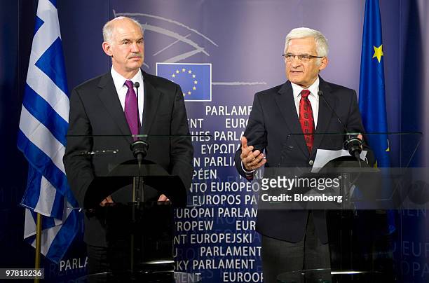 Jerzy Buzek, president of the European Parliament, right,speaks as George Papandreou, Greece's prime minister, listens during their press briefing at...
