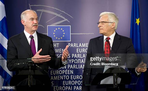Jerzy Buzek, president of the European Parliament, right, listens as George Papandreou, Greece's prime minister, speaks during their press briefing...