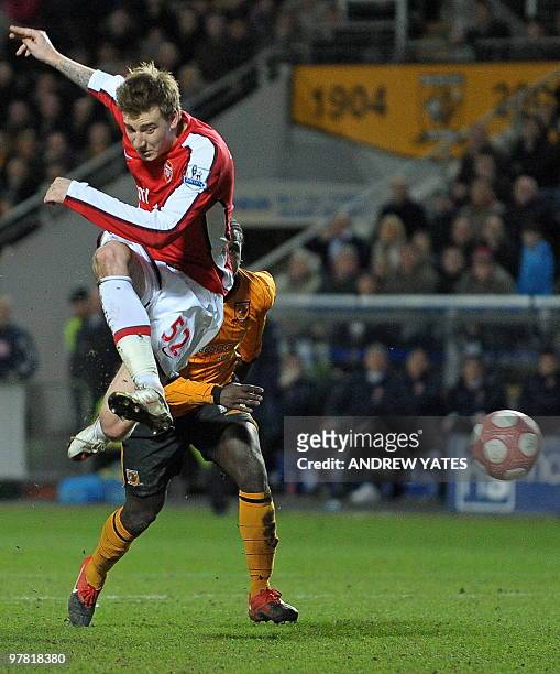 Arsenal's Danish forward Nicklas Bendtner scores the late second goal in the English Premier League football match between Hull City and Arsenal at...