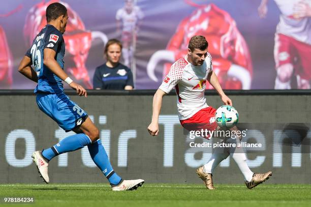 April 2018, Germany, Leipzig: Football, German Bundesliga, RB Leipzig vs 1899 Hoffenheim at the Red Bull Arena: Hoffenheim's Kevin Akpoguma and...