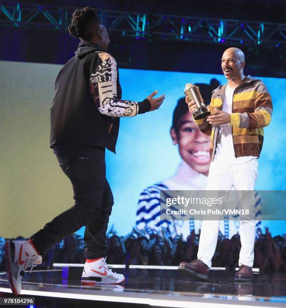 Filmmaker Lena Waithe accepts the MTV Trailblazer Award from rapper Common onstage during the 2018 MTV Movie And TV Awards at Barker Hangar on June...