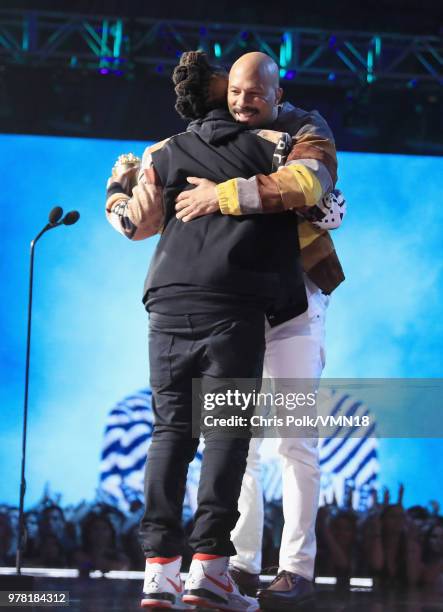 Filmmaker Lena Waithe accepts the MTV Trailblazer Award from rapper Common onstage during the 2018 MTV Movie And TV Awards at Barker Hangar on June...