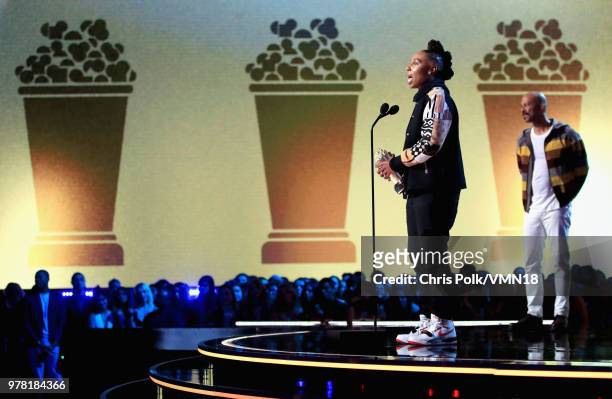 Filmmaker Lena Waithe accepts the MTV Trailblazer Award from rapper Common onstage during the 2018 MTV Movie And TV Awards at Barker Hangar on June...