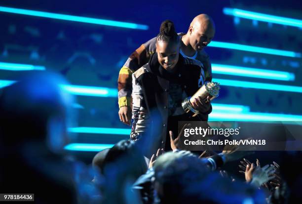 Filmmaker Lena Waithe accepts the MTV Trailblazer Award from rapper Common onstage during the 2018 MTV Movie And TV Awards at Barker Hangar on June...