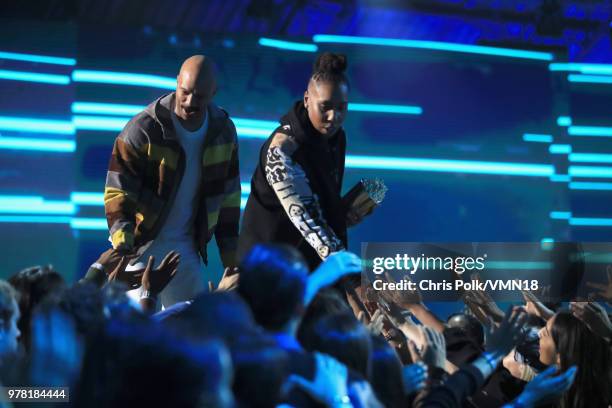 Filmmaker Lena Waithe accepts the MTV Trailblazer Award from rapper Common onstage during the 2018 MTV Movie And TV Awards at Barker Hangar on June...