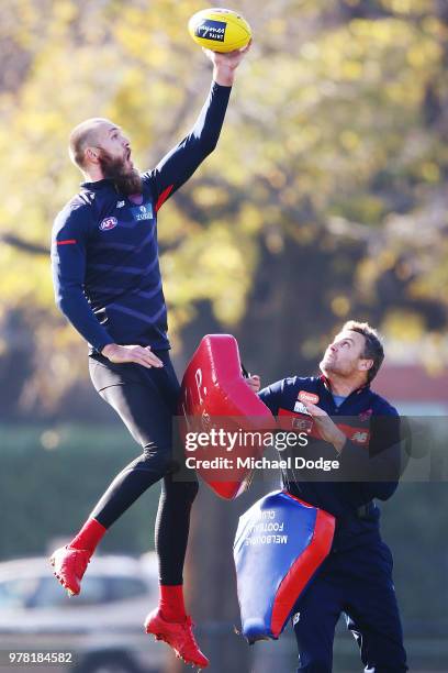 Max Gawn of the Demons competes for the ball over ruck coach Grant Stafford during a Melbourne Demons AFL training session at Gosch's Paddock on June...