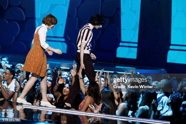 Actors Sophia Lillis and Finn Wolfhard accept the Best On-Screen Team award for 'It' onstage during the 2018 MTV Movie And TV Awards at Barker Hangar...