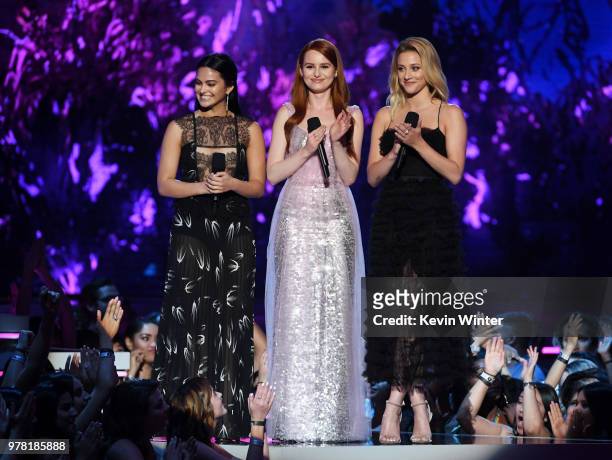Actors Camila Mendes, Madelaine Petsch, and Lili Reinhart speak onstage during the 2018 MTV Movie And TV Awards at Barker Hangar on June 16, 2018 in...