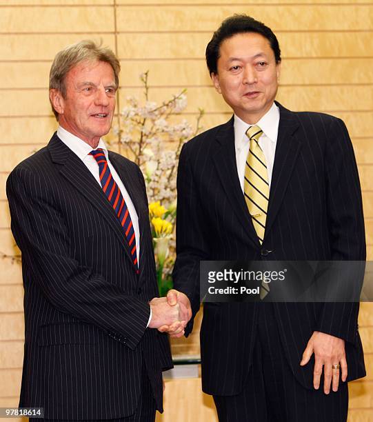 French foreign minister Bernard Kouchner shakes hands with Japanese Prime Minister Yukio Hatoyama prior to their talks at Hatoyama's official...