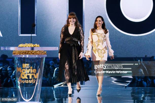 Actors Bryce Dallas Howard and Aubrey Plaza walk onstage during the 2018 MTV Movie And TV Awards at Barker Hangar on June 16, 2018 in Santa Monica,...