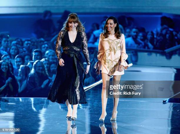 Actors Bryce Dallas Howard and Aubrey Plaza walk onstage during the 2018 MTV Movie And TV Awards at Barker Hangar on June 16, 2018 in Santa Monica,...