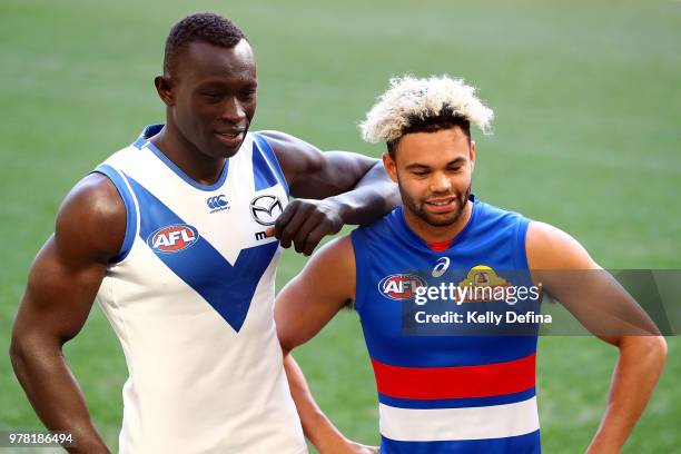 Majak Daw of the Kangaroos and Jason Johannisen of the Bulldogs pose during an AFL press conference at Etihad Stadium on June 19, 2018 in Melbourne,...