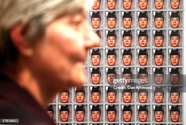 Diane Douglas, the mother of Corporal Alan Douglas who was killed in Iraq looks a piece of artwork entitled 'Queen and Country' with the face of her...