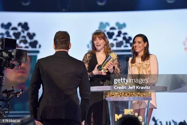 Actor Chris Patt accepts award from Bryce Dallas Howard and Aubrey Plaza onstage at the 2018 MTV Movie And TV Awards at Barker Hangar on June 16,...