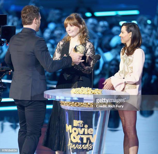 Actor Chris Pratt accepts the MTV Generation Award from actors Bryce Dallas Howard and Aubrey Plaza during the 2018 MTV Movie And TV Awards at Barker...