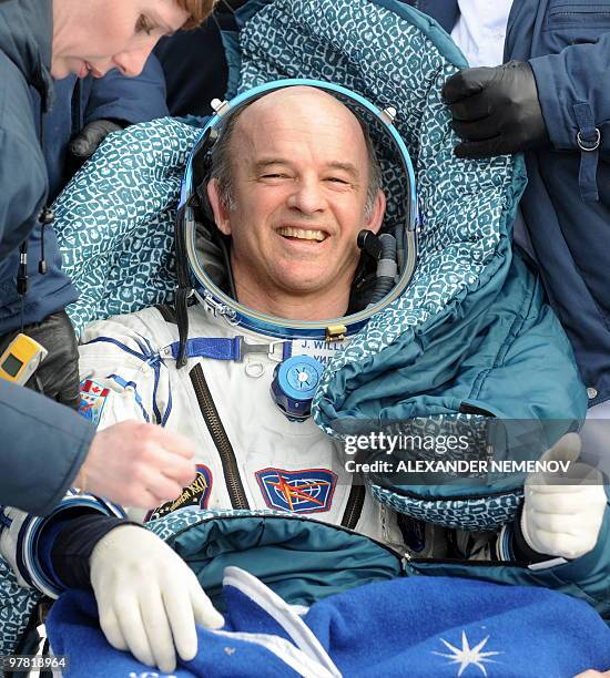 Astronaut Jeffrey Williams gets assistance after landing in Russian "Soyuz TMA-16" space capsule not far from the Kazakh town of Arkalyk on March 18...