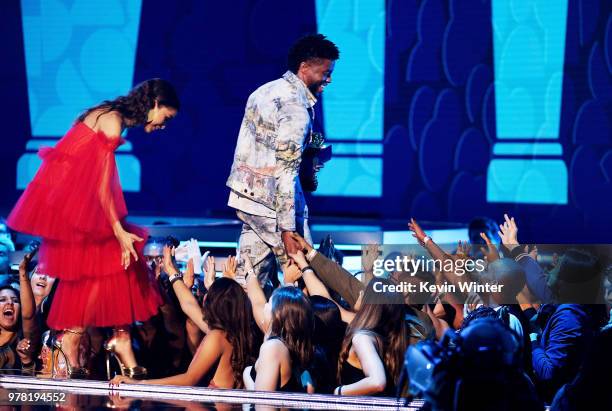 Actor-recording artist Zendaya and actor Chadwick Boseman, winner of the Best Performance in a Movie award for 'Black Panther,' walk onstage during...