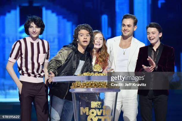 Actors Finn Wolfhard, Gaten Matarazzo, Sadie Sink, Dacre Montgomery, and Noah Schnapp speak onstage at the 2018 MTV Movie And TV Awards at Barker...