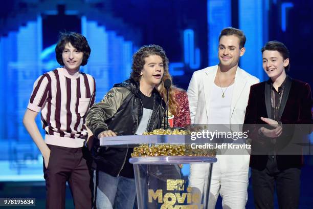 Actors Finn Wolfhard, Gaten Matarazzo, Sadie Sink, Dacre Montgomery, and Noah Schnapp speak onstage at the 2018 MTV Movie And TV Awards at Barker...