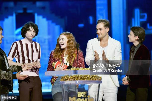 Actors Finn Wolfhard, Gaten Matarazzo, Sadie Sink, Dacre Montgomery, and Noah Schnapp speak onstage at the 2018 MTV Movie And TV Awards at Barker...