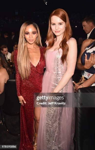 Actors Vanessa Morgan and Madelaine Petsch attend the 2018 MTV Movie And TV Awards at Barker Hangar on June 16, 2018 in Santa Monica, California.