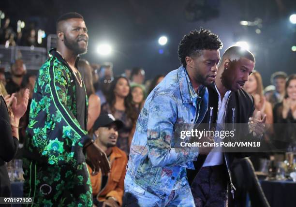 Actors Winston Duke, Chadwick Boseman, and Michael B. Jordan, winners of the Best Movie award for 'Black Panther' walk onstage during the 2018 MTV...