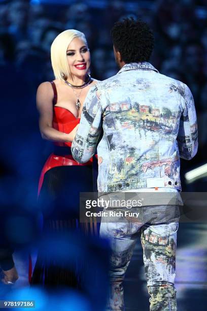 Actor Chadwick Boseman accepts the Best Movie award for 'Black Panther' from singer/actor Lady Gaga onstage during the 2018 MTV Movie And TV Awards...