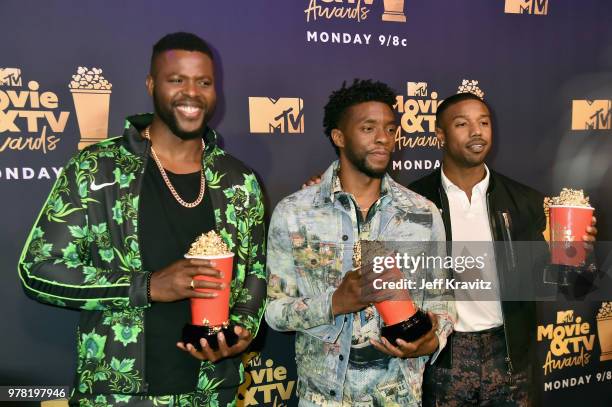 Actors Winston Duke, Chadwick Boseman, and Michael B. Jordan attend the 2018 MTV Movie And TV Awards at Barker Hangar on June 16, 2018 in Santa...