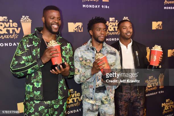 Actors Winston Duke, Chadwick Boseman, and Michael B. Jordan attend the 2018 MTV Movie And TV Awards at Barker Hangar on June 16, 2018 in Santa...