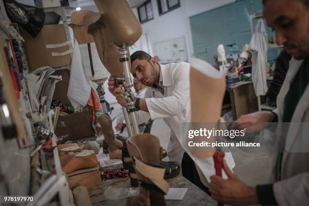 Dpatop - Staff members of Gaza's Artificial Limbs and Polio Centre prepare prosthetic legs, in Gaza City, 22 April 2018. The ALPC was established in...