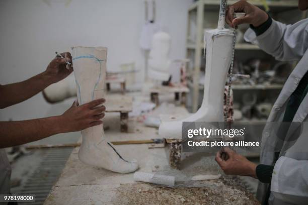Dpatop - Staff members of Gaza's Artificial Limbs and Polio Centre prepare prosthetic legs, in Gaza City, 22 April 2018. The ALPC was established in...