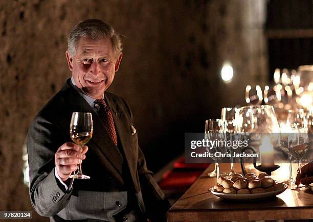 Prince Charles, Prince of Wales tastes wine in a cellar as he visits the open air museum of Skanzen on March 18, 2010 in Budapest, Hungary. Prince...