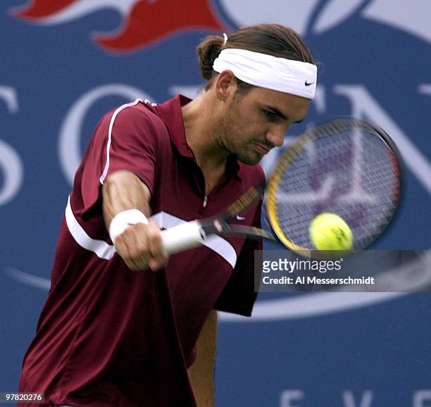 Roger Federer follows through on a one-handed backhand Thursday, September 4, 2003 at the U. S. Open in New York. Federer, the second seed from...
