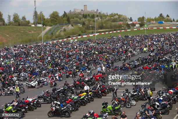 April 2018, Germany, Nuerburg: Thousands of motorcyclists taking part in the parade for this season's start at the Nuerburgring running under the...