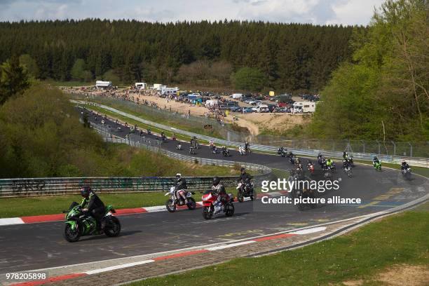 April 2018, Germany, Nuerburg: Thousands of motorcyclists taking part in the parade for this season's start at the Nuerburgring running under the...