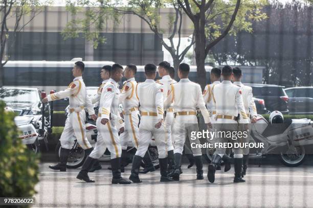 Chinese bikers honour guards walk at the airport's VIP gate, as North Korean leader Kim Jong Un visits China, in Beijing on June 19, 2018. The trip...
