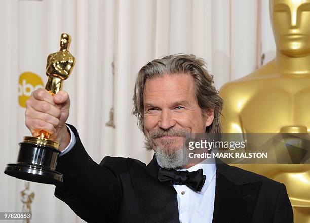 Actor Jeff Bridges celebrates his Oscar for best actor for his portrayal of an alcoholic country singer in the drama "Crazy Heart" during the 82nd...