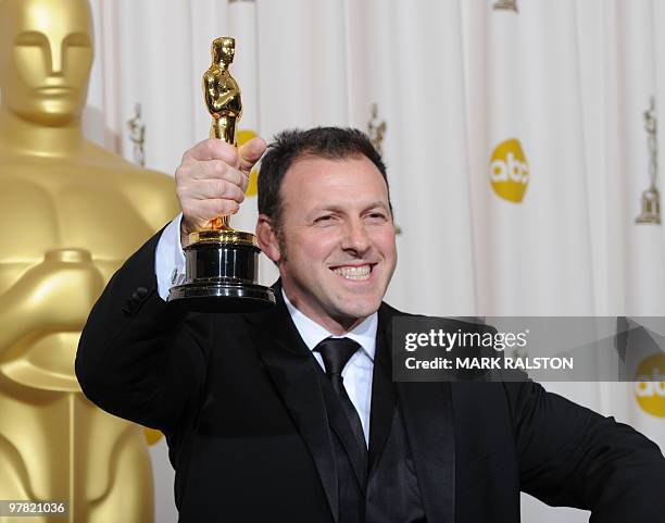 Mauro Fiore of Italy celebrates his Oscar for Achievement in Cinematography for "Avatar" during the 82nd Academy Awards at the Kodak Theater in...